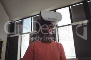 Low angle view of boy wearing virtual reality simulator