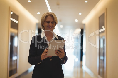 Smiling businesswoman using tablet computer