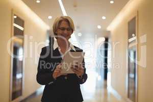 Smiling businesswoman using tablet computer