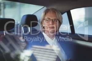 Thoughtful businesswoman traveling in car