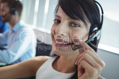 Portrait of smiling businesswoman using headset