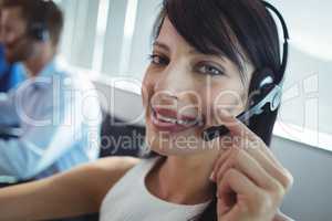 Portrait of smiling businesswoman using headset