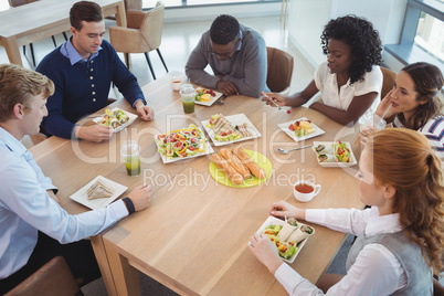 Business people having breakfast at office cafeteria