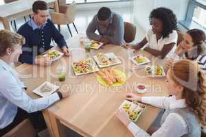 Business people having breakfast at office cafeteria