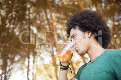 Low angle view of young man drinking beer
