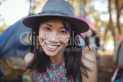 Portrait of smiling young woman wearing gray hat