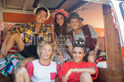 Portrait of smiling friends together in camper van
