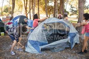 Young friends setting up tents on field