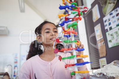Curious elementary student looking at model