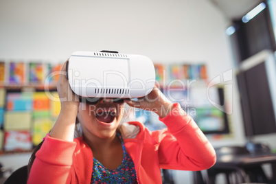 Cheerful girl using virtual reality glasses