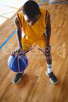 High angle view teenage boy practicing basketball