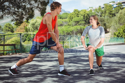Friends talking while exercising on road