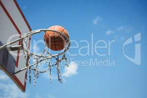 Low angle view of basketball in hoop