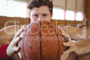 Close up portrait of male basketball player holding ball