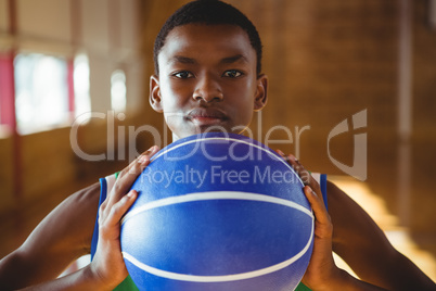 Close up portrait of serious man with basketball