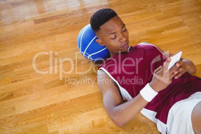 High angle view of male basketball player using mobile phone