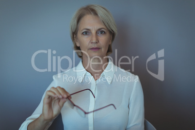 Portrait of businesswoman against wall