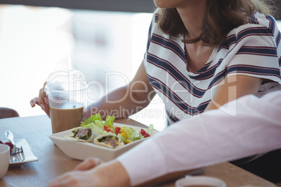 High angle view of business colleagues having breakfast at table