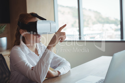 Businesswoman using virtual reality technology in office