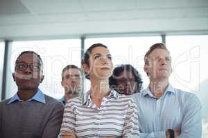 Thoughtful business colleagues standing together