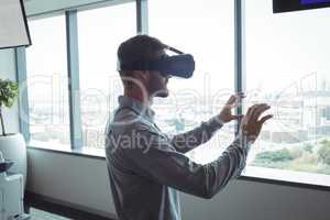Side view of businessman using virtual reality glasses