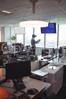 Businessman using virtual reality technology at office