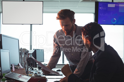 Male business colleagues working together in office