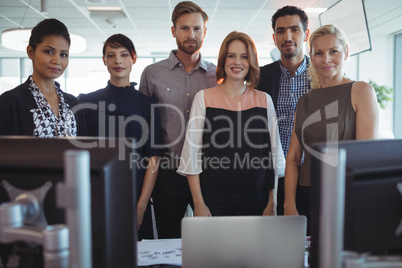 Portrait of young business colleagues standing together