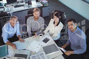 High angle portrait of business people discussing in meeting