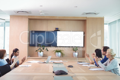 Business people clapping during meeting