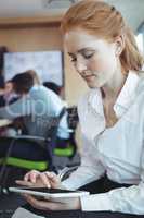Young businesswoman using digital tablet at office