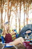 Happy young woman taking selfie at campsite