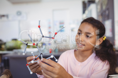 Elementary student holding molecule model
