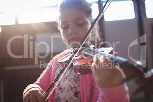 Girl student rehearsing violin