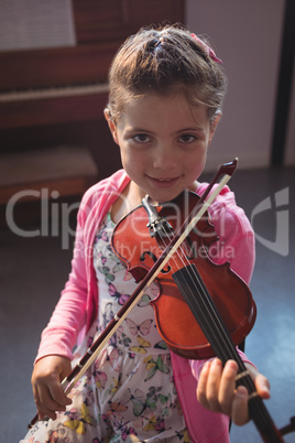 Portrait of girl student rehearsing violin