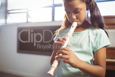 Girl practicing flute in class