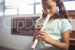 Girl practicing flute in class