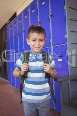 Portrait of smiling boy standing in corridor