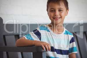 Portrait of smiling boy sitting on bench