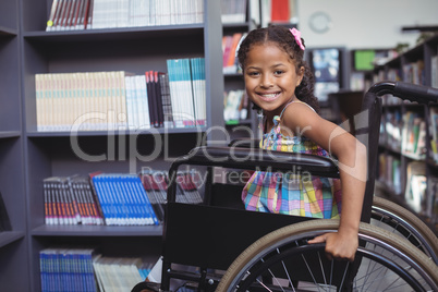 Smiling girl on wheelchair at library
