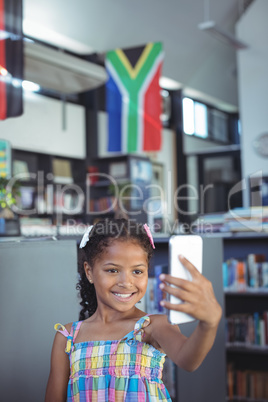 Girl taking selfie in library