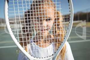 Girl seen through tennis racket
