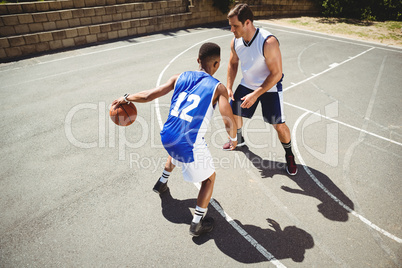 Basketball players playing in court