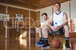 Portrait of basketball players sitting on bench