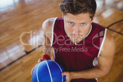 High angle portrait of basketball player holding ball