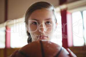Close-up portrait of woman with basketball