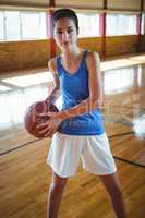 Portrait young woman with basketballl