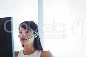 Businesswoman wearing headset at call center