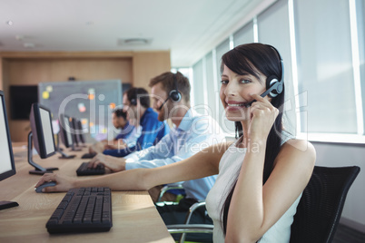 Portrait of happy businesswoman using headset