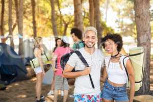 Portrait of smiling couple with friends in background